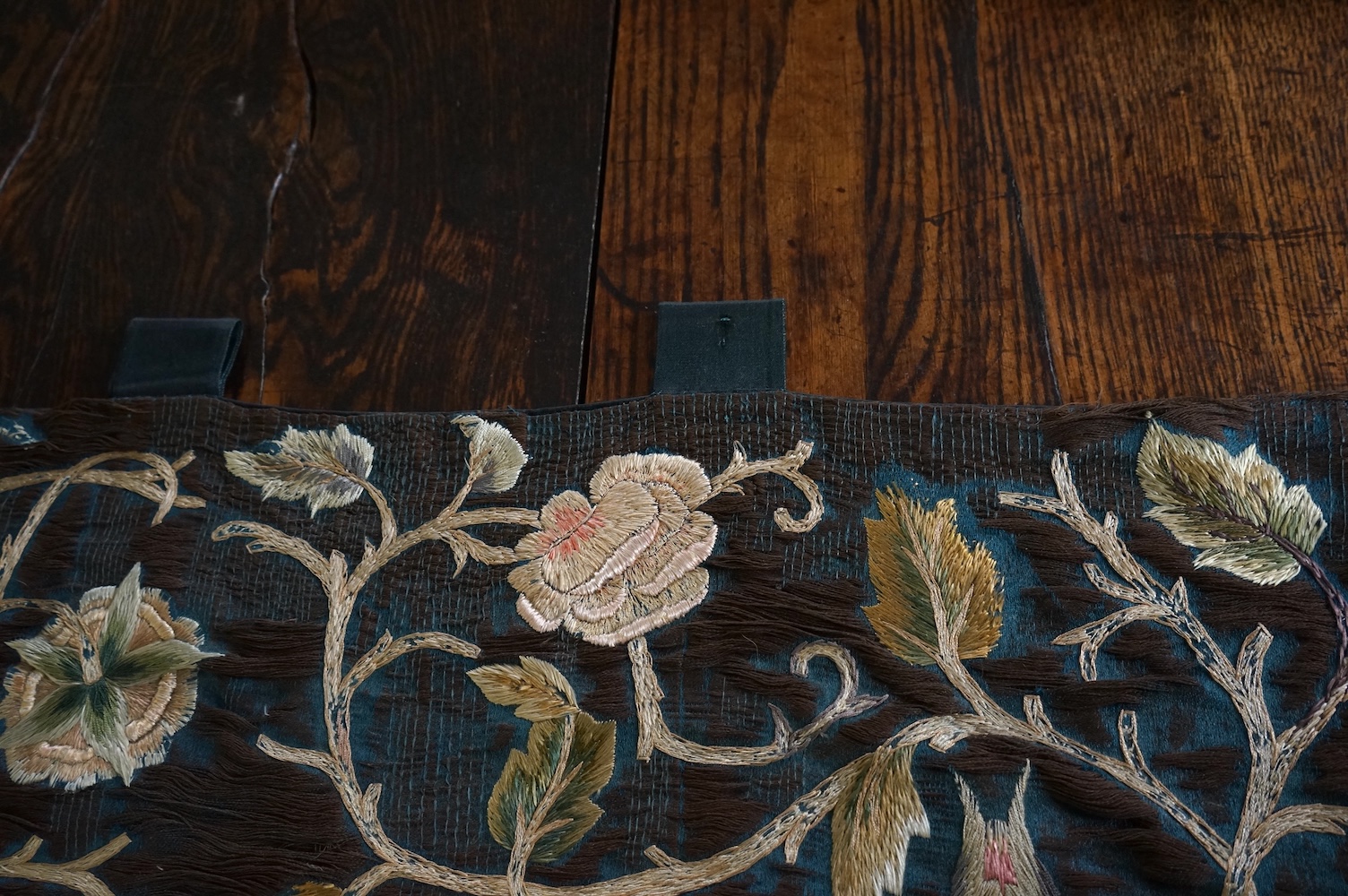 A large Arts and Crafts silk embroidered wall hanging, embroidered in the manner of May Morris with a large central scrolling flowering rose tree and banner embroidered with Salve and a two row motto below;, Rose leaves